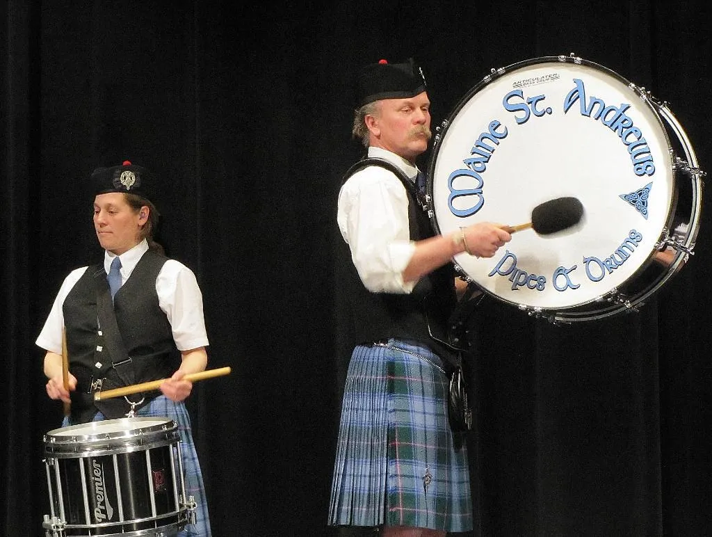 An MSAPD snare drummer and bass drummer performing; the bass drum reads Maine St. Andrew's Pipes & Drums